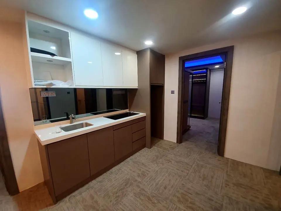 Kitchenette with gloss white upper cabinets