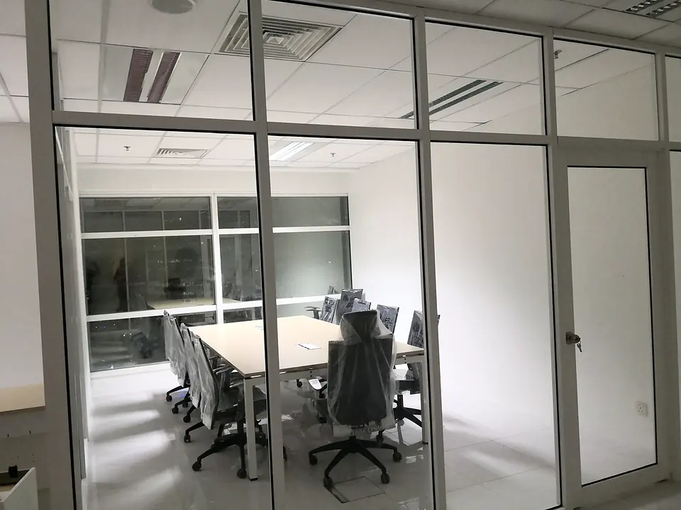 Meeting room behind a full-height glass partition