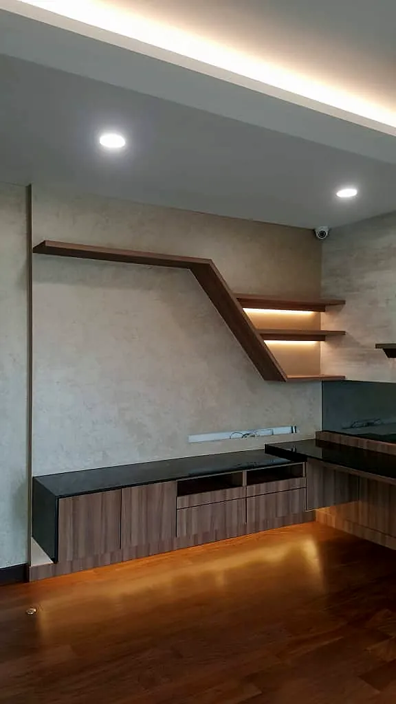 TV wall with angled timber shelves and lit coves