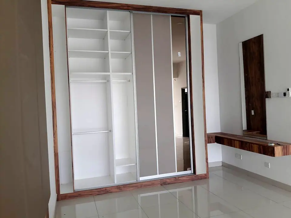 Wardrobe in a timber frame beside a floating dressing table